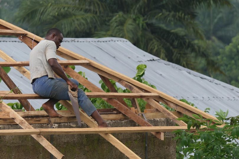 a picture showing a carpenter working on the roof akodi orisa
