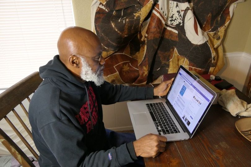 a picture showing moyo okediji working on his laptop