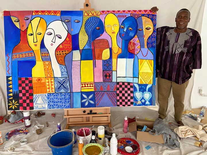 Adetola Wewe posing with the first painting…